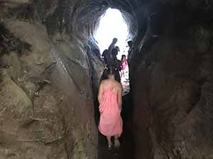 Children walking through cave